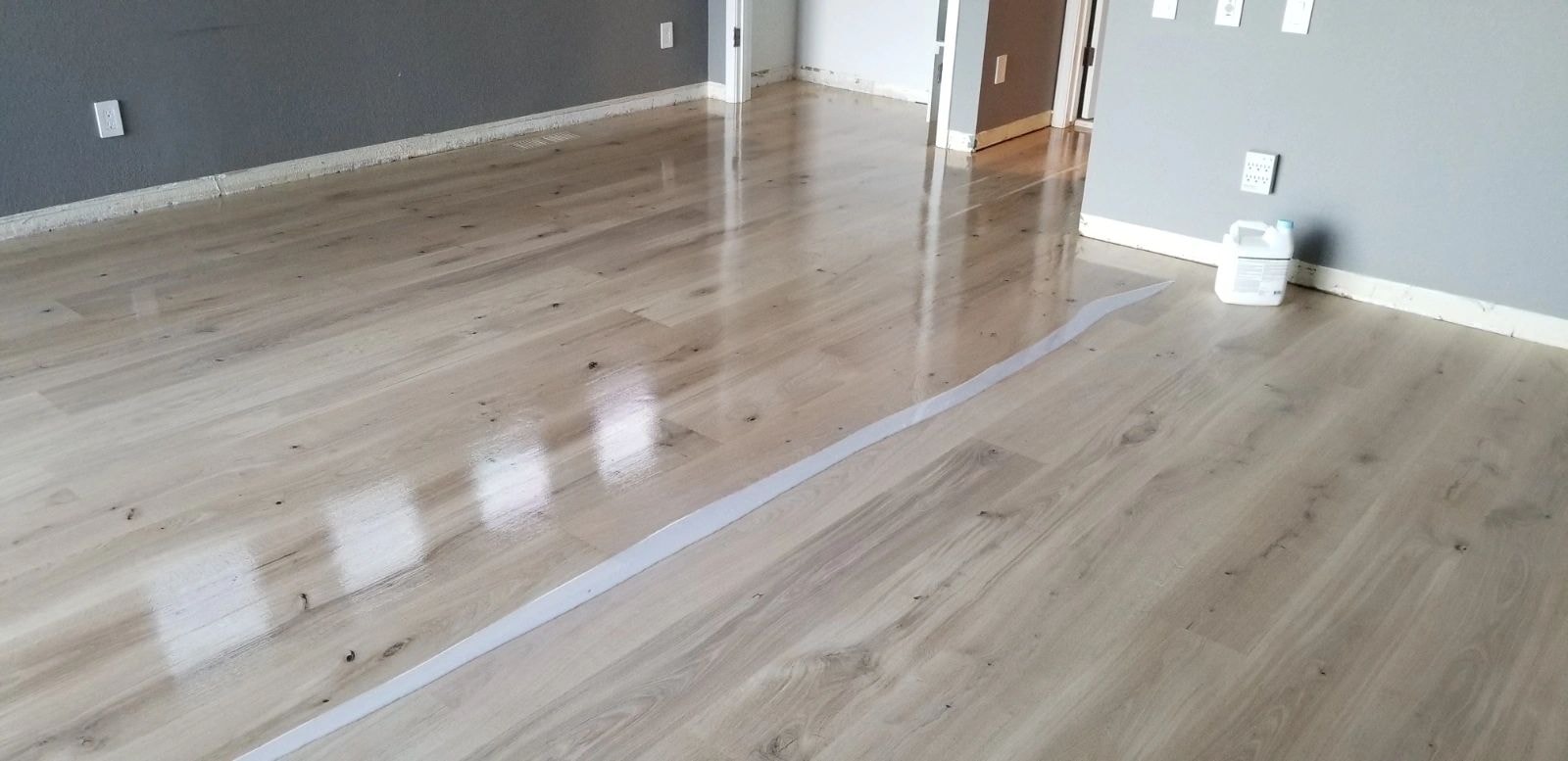 Empty room with polished wood flooring installation