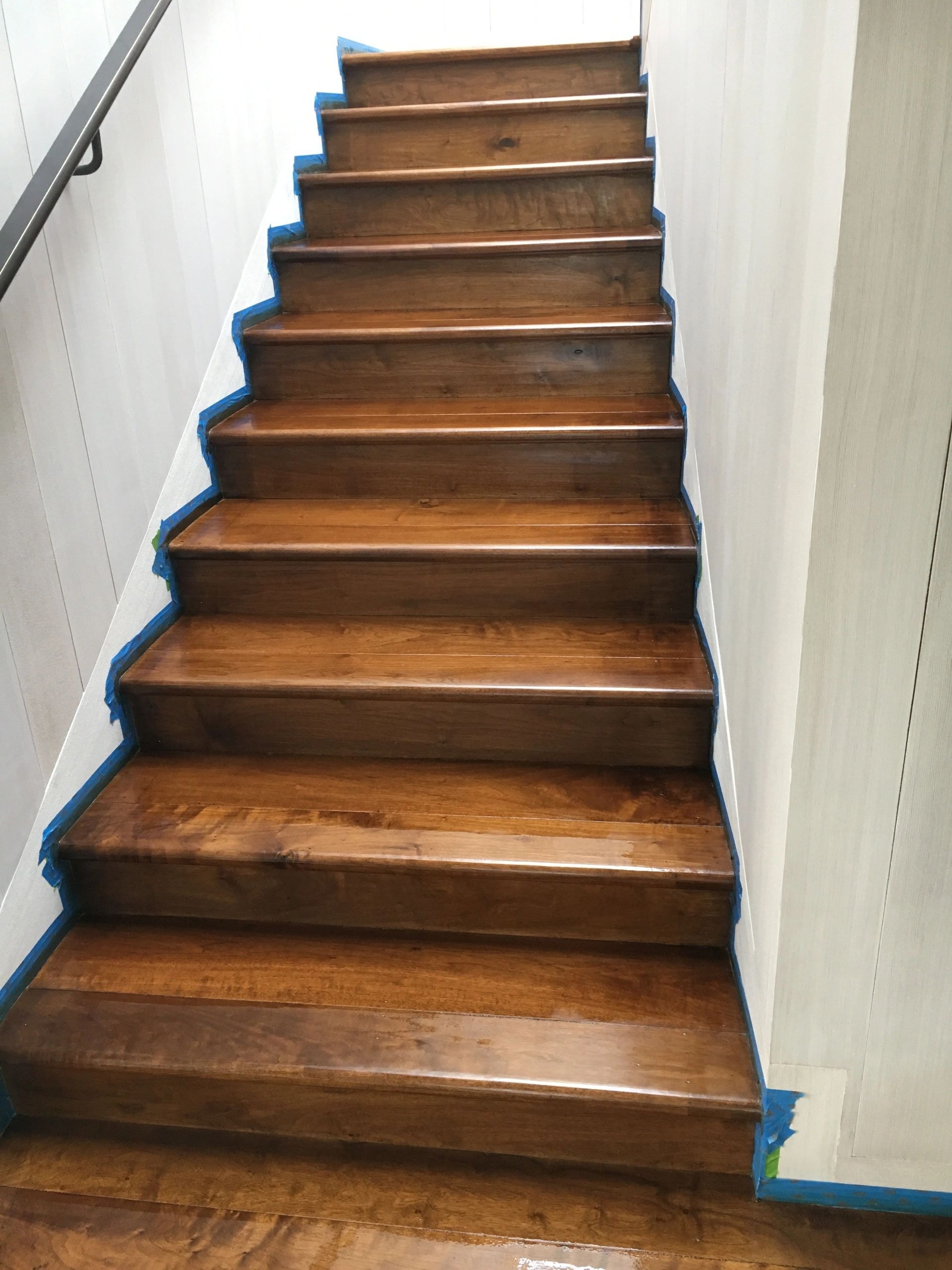 Staircase with wooden treads and blue painters tape