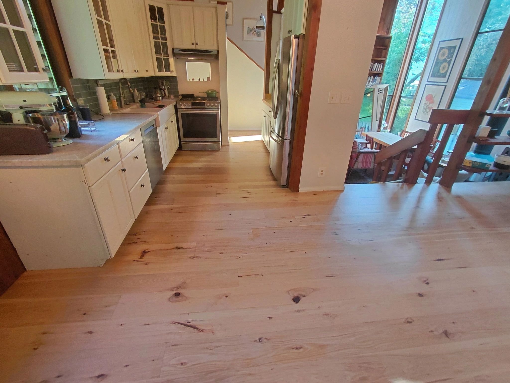 Modern kitchen with cream cabinets and hardwood floors